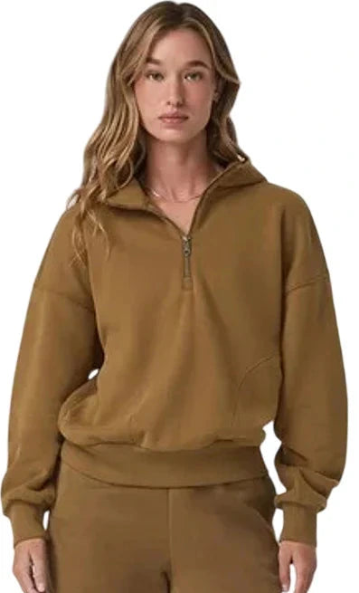 Person wearing a brown tracksuit on a white background