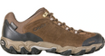Brown hiking shoe with black sole on a white background